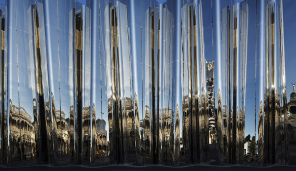 The Len Lye Centre, with buildings reflected in its surface.