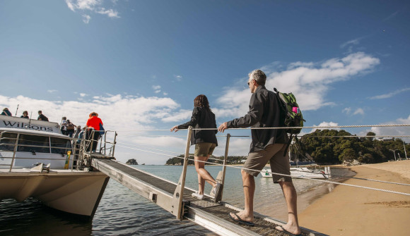 Tourists board a boat in Abel Tasman National Park