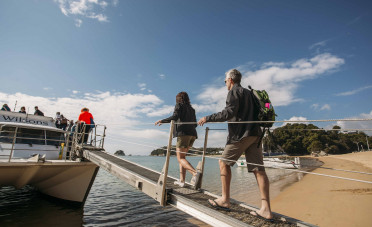 Tourists board a boat in Abel Tasman National Park