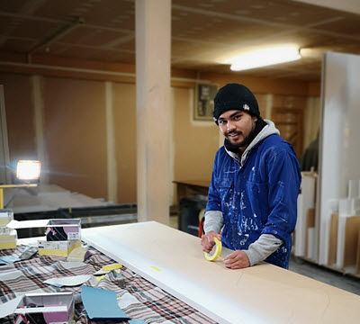 Dean Taiti standing at a workbench.