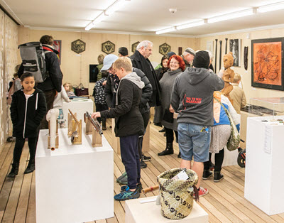 A group of people viewing art at the Hihaua Cultural Centre