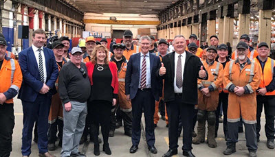 Shane Jones and David Parker with KiwiRail Hillside Workshop staff.