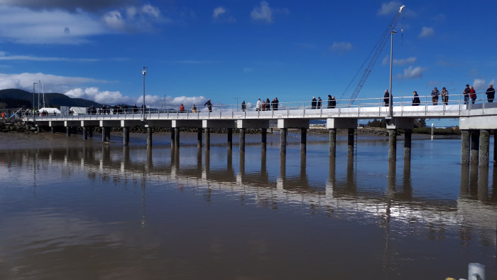 A 80-metre commercial wharf and floating pontoon in front of a bright blue sky.
