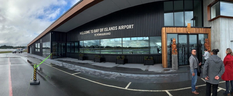 Four people in front of the new terminal building at Bay of Islands Airport.