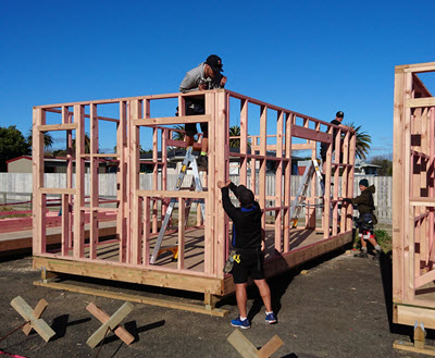 Four apprentices work on a construction site.