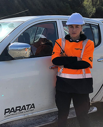 Parata Contracting employee, Te Rangi Marie Bartlett, standing next to work vehicle.