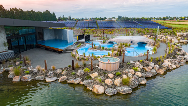 Modern outdoor hot pools with rocks around the edges