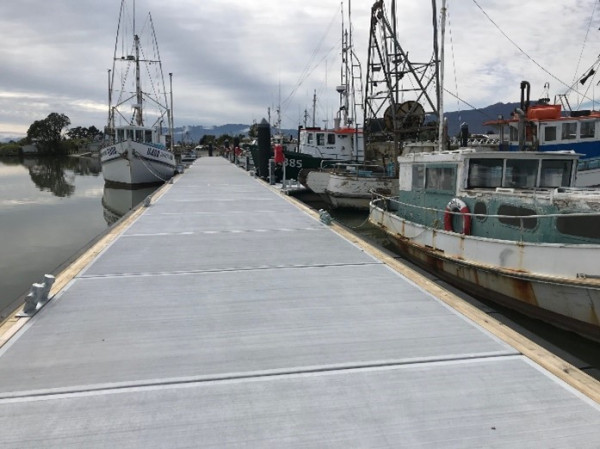 A newly built wharf with boast docked on each side of it